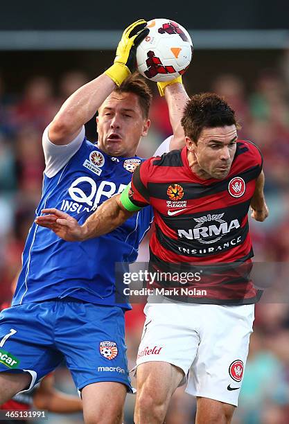 Daniel Vukovic of the Glory makes a save as Michael Beauchamp of the Wanderers contests possession during the round 16 A-League match between the...