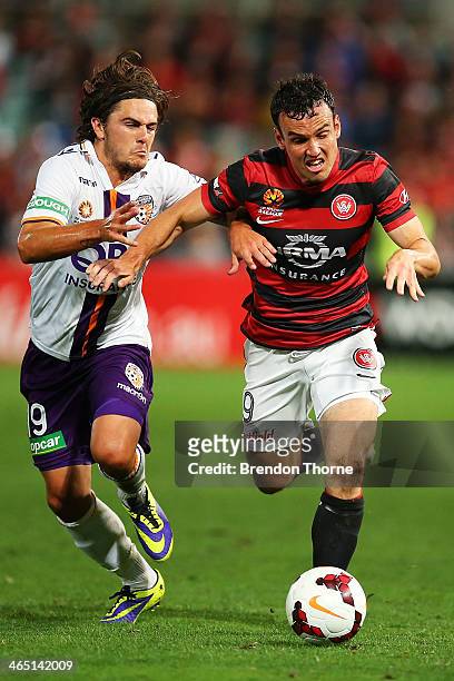 Mark Bridge of the Wanderers competes with Joshua Risdon of the Glory during the round 16 A-League match between the Western Sydney Wanderers and...
