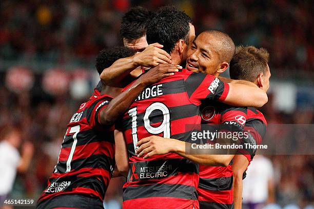 Mark Bridge of the Wanderers celebrates with team mates after scoring a penalty during the round 16 A-League match between the Western Sydney...