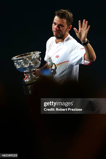 Stanislas Wawrinka of Switzerland holds the Norman Brookes Challenge Cup after winning his men's final match against Rafael Nadal of Spain during day...