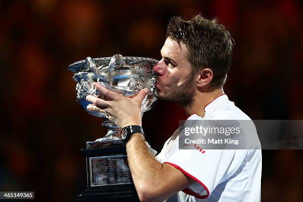 Stanislas Wawrinka of Switzerland kisses the Norman Brookes Challenge Cup after winning his men's final match against Rafael Nadal of Spain during...