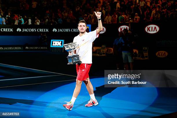 Stanislas Wawrinka of Switzerland holds the Norman Brookes Challenge Cup after winning his men's final match against Rafael Nadal of Spain during day...