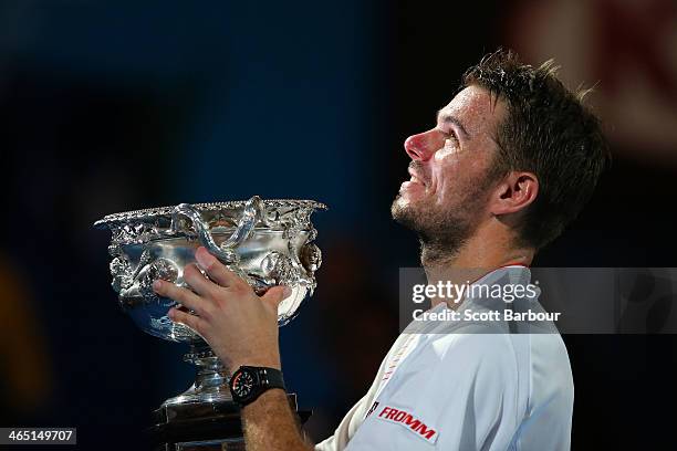 Stanislas Wawrinka of Switzerland holds the Norman Brookes Challenge Cup after winning his men's final match against Rafael Nadal of Spain during day...