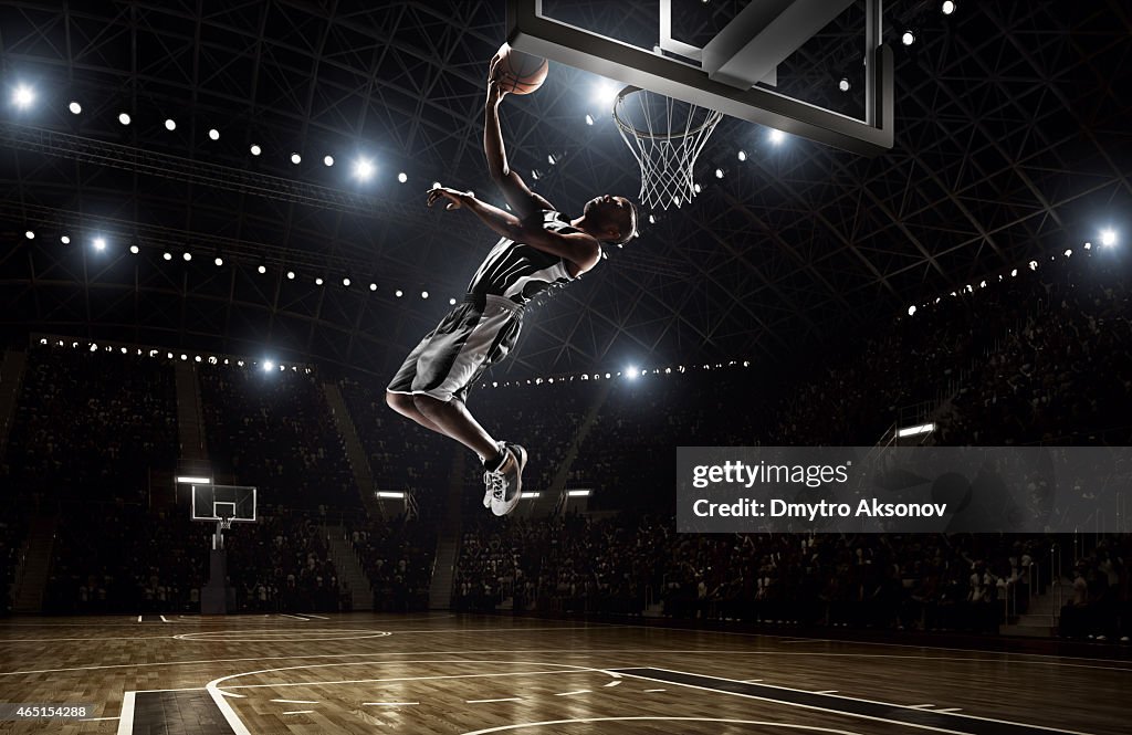 Basketball player makes slam dunk