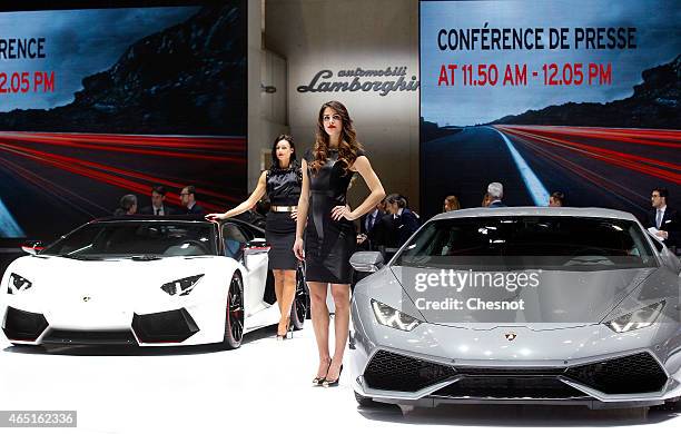 Models pose next to a lamborghini Huracan during the 85th Geneva International Motor Show on March 3, 2015 in Geneva, Switzerland. The International...