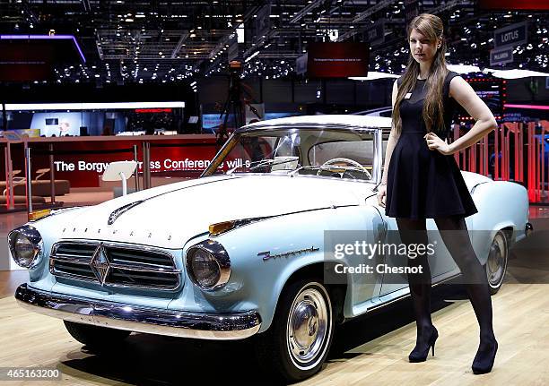 Model poses next to a Borgward during the 85th Geneva International Motor Show on March 3, 2015 in Geneva, Switzerland. After more than 50 years...
