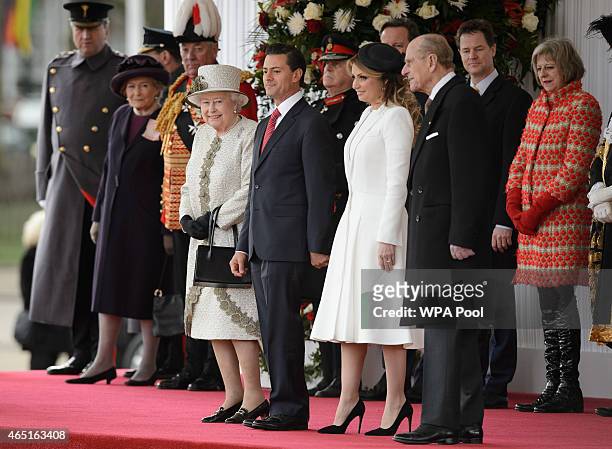 Queen Elizabeth II, President of Mexico Enrique Pena Nieto and his wife Angelica Rivera, and Prince Philip prepare to listen to the national anthem...