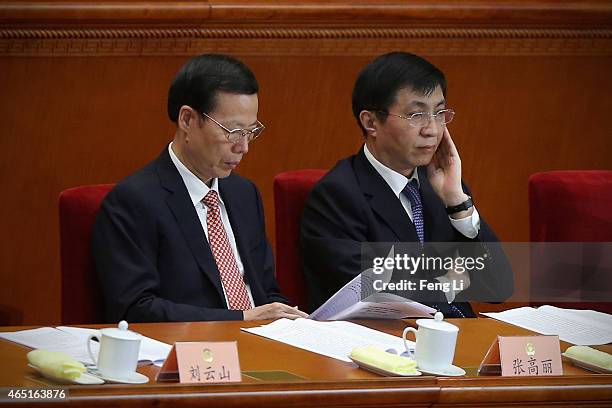 Members of the Political Bureau of the CPC Central Committee Wang Huning and Zhang Gaoli attend the opening session of the Chinese People's Political...