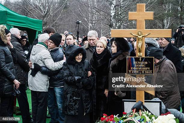 People embrace at the grave of Russian opposition leader Boris Nemtsov at Troyekurovskoye Cemetary on March 3, 2015 in Moscow, Russia. Nemtsov was...