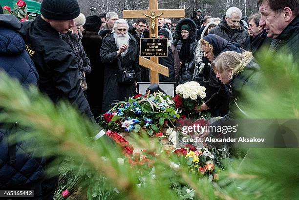 People place flowers near the grave of Russian opposition leader Boris Nemtsov at Troyekurovskoye Cemetary on March 3, 2015 in Moscow, Russia....