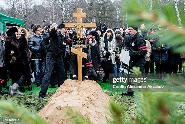 Workers place a cross to the grave of Russian opposition leader Boris Nemtsov at Troyekurovskoye Cemetary on March 3, 2015 in Moscow, Russia. Nemtsov...