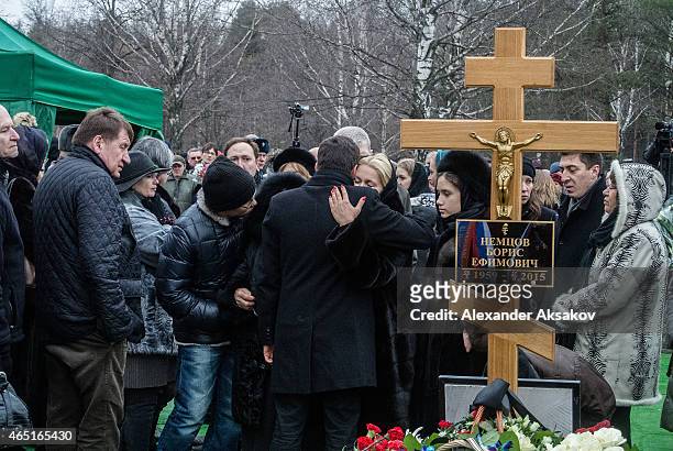 People embrace at the grave of Russian opposition leader Boris Nemtsov at Troyekurovskoye Cemetary on March 3, 2015 in Moscow, Russia. Nemtsov was...