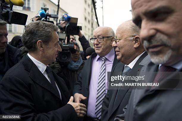 Former French President and head of UMP right-wing party Nicolas Sarkozy , shakes hand with an unidentified person as he is is welcomed by Dalil...