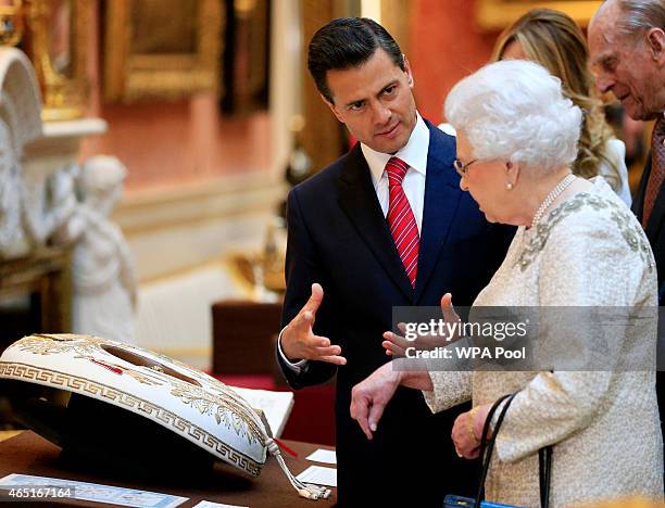 The President of Mexico Enrique Pena Nieto is shown Mexican items in the Royal Collection by Queen Elizabeth II at Buckingham Palace on March 3, 2015...