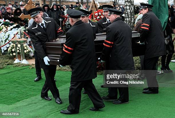 Funeral assistants carry the coffin of Russian opposition leader Boris Nemtsov during his funeral at Troyekurovskoe cemetery in Moscow on March 3,...