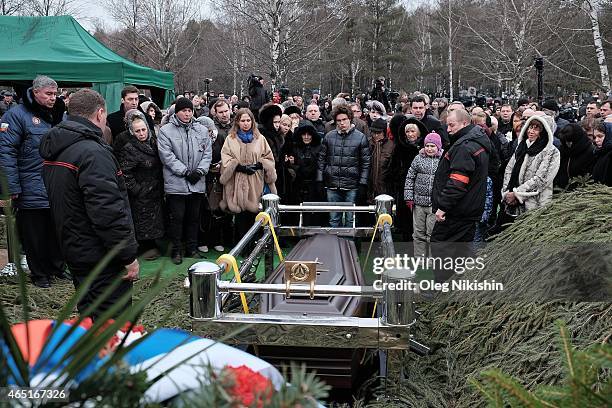 Relatives and friends near the grave of opposition leader Boris Nemtsov during his funeral at Troyekurovskoe cemetery in Moscow on March 3, 2015....