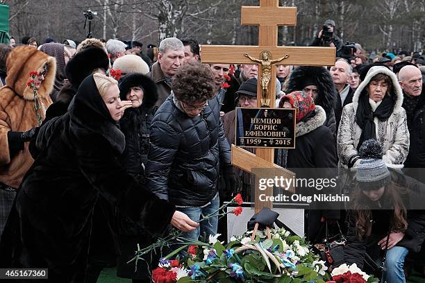 Ekaterina Odintsova, Dina Eidman Anton Nemtsov near the grave of opposition leader Boris Nemtsov during his funeral at Troyekurovskoe cemetery in...