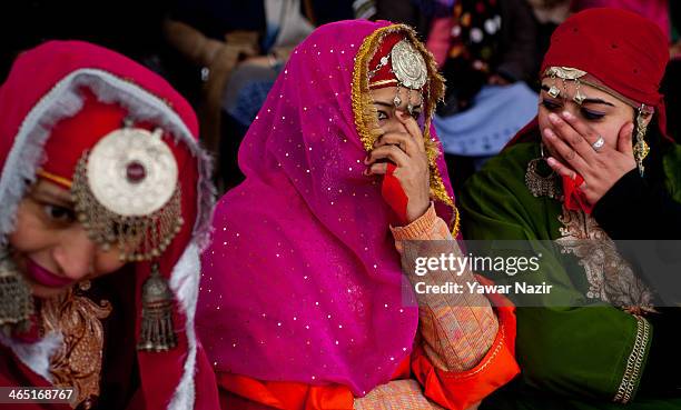 Group of Kashmiri Muslim girls in a Kashmiri traditional attire shares a joke as they watch the program at the Bakshi stadium , where the authorities...