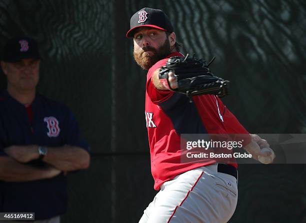 Boston Red Sox manager John Farrell watches pitcher Mitchell Boggs work in a bullpen session.