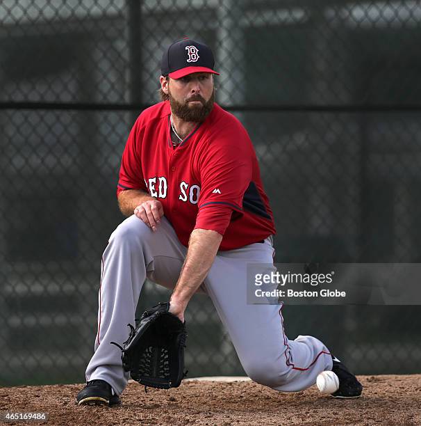 Boston Red Sox pitcher Mitchell Boggs fields a comeback during the "Rag Ball" drill.