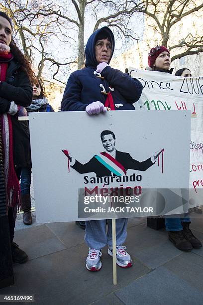 Protester holds a placard during a demonstration outside Downing Street in central London on March 3, 2015 over the abduction of 43 students in...