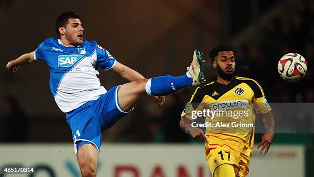 Kevin Volland of Hoffenheim is challenged by Phil Ofosu-Ayeh of Aalen during the DFB Cup Round of 16 match between VfR Aalen and 1899 Hoffenheim at...