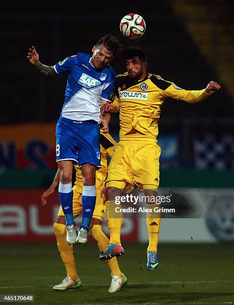 Eugen Polanski of Hoffenheim jumps for a header with Juergen Gjasula of Aalen during the DFB Cup Round of 16 match between VfR Aalen and 1899...