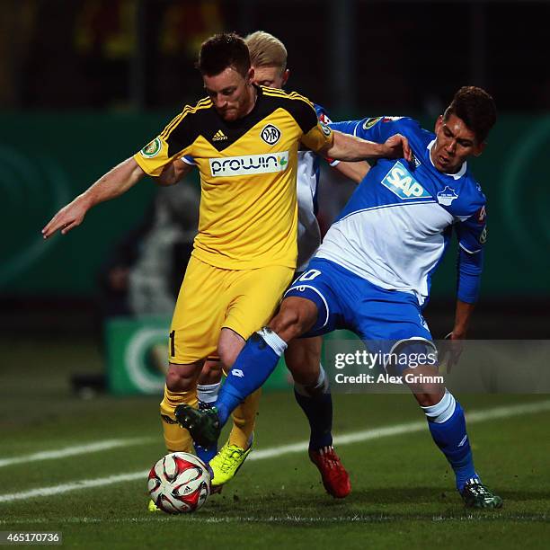 Michael Klauss of Aalen is challenged by Roberto Firmino of Hoffenheim during the DFB Cup Round of 16 match between VfR Aalen and 1899 Hoffenheim at...