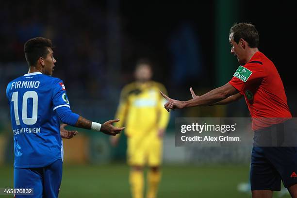 Referee Sascha Stegemann talks to Roberto Firmino of Hoffenheim during the DFB Cup Round of 16 match between VfR Aalen and 1899 Hoffenheim at Scholz...