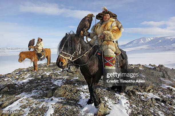 epic kazakh golden eagle hunters on horseback - independent mongolia stock-fotos und bilder