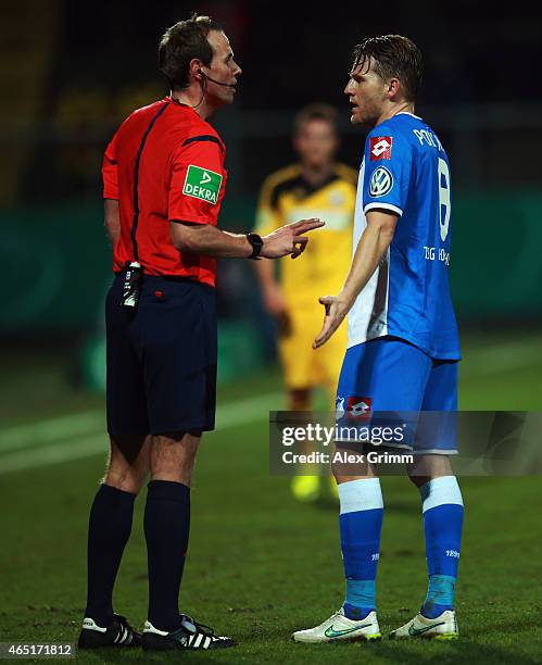 Referee Sascha Stegemann talks to Eugen Polanski of Hoffenheim during the DFB Cup Round of 16 match between VfR Aalen and 1899 Hoffenheim at Scholz...