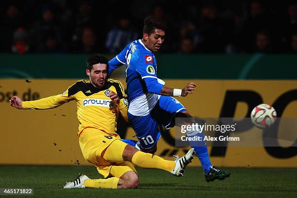 Roberto Firmino of Hoffenheim is challenged by Sascha Mockenhaupt of Aalen during the DFB Cup Round of 16 match between VfR Aalen and 1899 Hoffenheim...