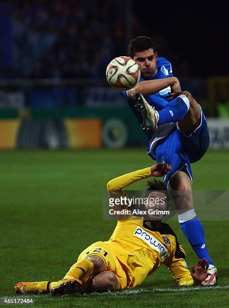 Kevin Volland of Hoffenheim is challenged by Fabio Kaufmann of Aalen during the DFB Cup Round of 16 match between VfR Aalen and 1899 Hoffenheim at...