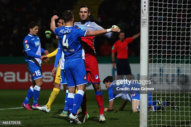 Goalkeeper Jens Grahl of Hoffenheim celebrates with team mate Ermin Bicakcic after a save during the DFB Cup Round of 16 match between VfR Aalen and...