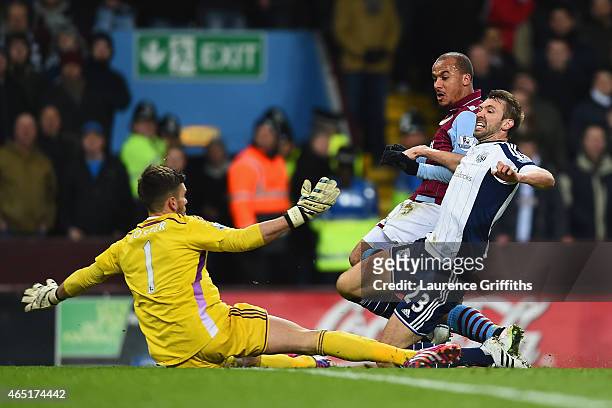Gabriel Agbonlahor of Aston Villa scores the opening goal under pressure from Gareth McAuley and Ben Foster of West Brom during the Barclays Premier...