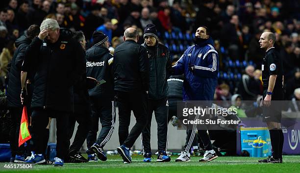 Hull manager Steve Bruce looks away as Sunderland manager Gus Poyet argues after Poyet is sent to the stand during the Barclays Premier League match...
