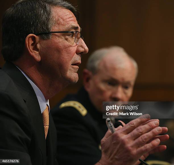 Defense Secretary Ashton Carter testifies while Chairman of the Joint Chiefs of Staff Army Gen. Martin Dempsey listens during a Senate Armed Services...