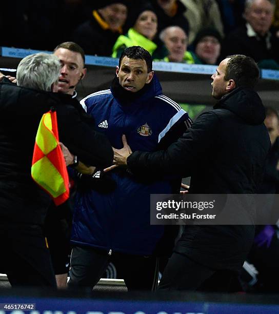 Hull manager Steve Bruce is held back by the assistant referee as he and Sunderland manager Gus Poyet (held back by Stephen Clemence argue after...