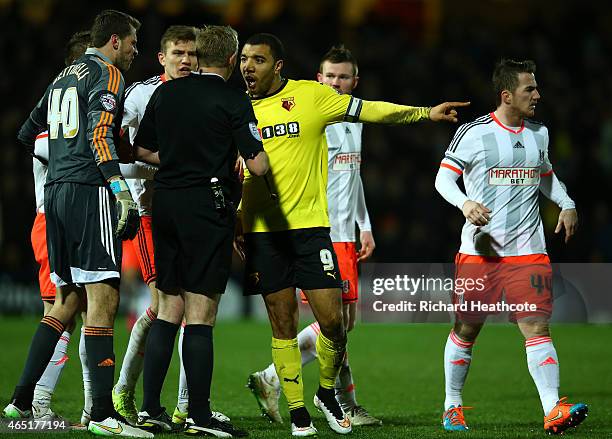 Troy Deeney of Watford remonstrates with referee Trevor Kettle during the Sky Bet Championship match between Watford and Fulham at Vicarage Road on...