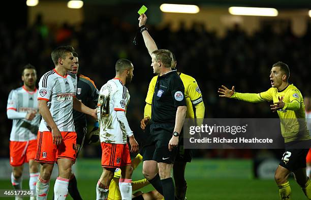 Ashley Richards of Fulham recieves a yellow card from referee Trevor Kettle after fouling Matej Vydra of Watford during the Sky Bet Championship...