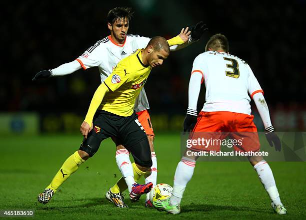 Adlene Guedioura of Watford takes on Kostas Stafylidis and Bryan Ruiz of Fulham during the Sky Bet Championship match between Watford and Fulham at...