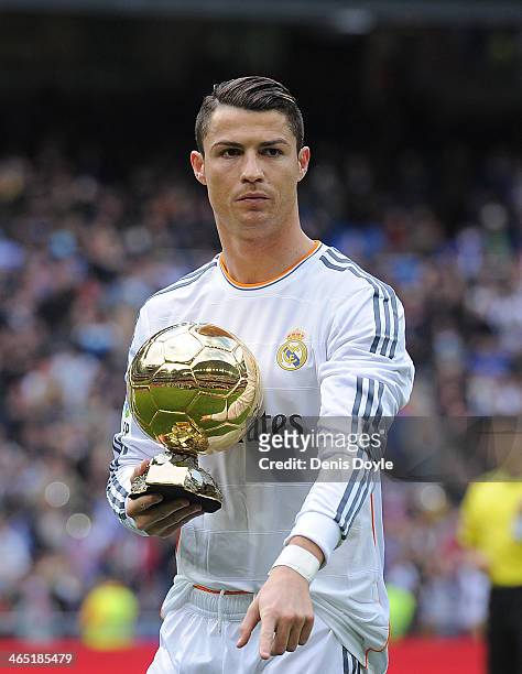 Cristiano Ronaldo of Real Madrid CF holds the Ballon d'Or 2013 award prior to the start of the La Liga match between Real Madrid CF and Granada CF at...