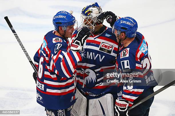 Martin Buchwieser, goalkeeper Dennis Endras and James Sifers of Mannheim celebrate after the DEL match between Adler Mannheim and Straubing Tigers at...