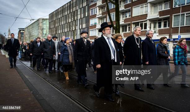 Mayor of Amsterdam Eberhard van der Laan leads a march from City Hall to the Auschwitz monument in the Wertheimpark in Amsterdam on January 26 during...