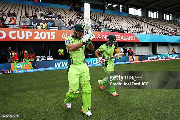 Nasir Jamshed and Ahmad Shahzad of Pakistan head out to bat during the 2015 ICC Cricket World Cup match between Pakistan and the United Arab Emirates...