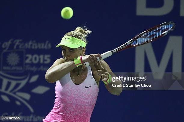 Sabine Lisicki of Germany plays a shot to Alexandra Dulgheru of Romania during day two of the BMW Malaysian Open at the Royal Selangor Golf Club...