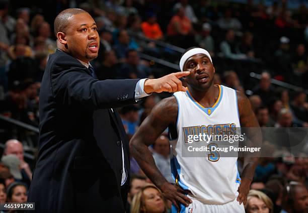 Interim head coach Melvin Hunt of the Denver Nuggets leads Ty Lawson and the Nuggets against the Milwaukee Bucks at Pepsi Center on March 3, 2015 in...