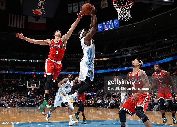 Ty Lawson of the Denver Nuggets has his shot blocked by Michael Carter-Williams of the Milwaukee Bucks at Pepsi Center on March 3, 2015 in Denver,...