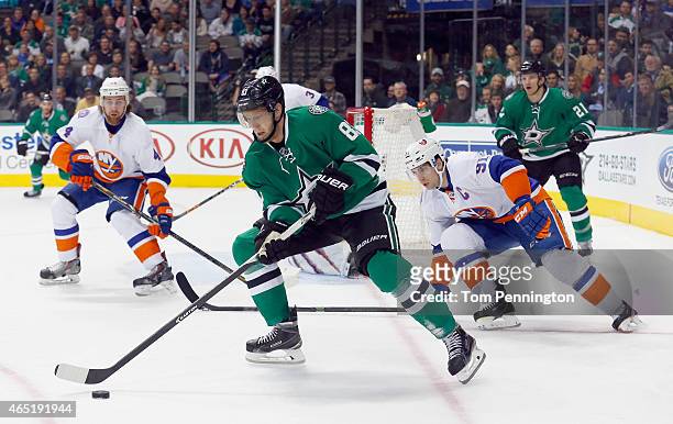 Ales Hemsky of the Dallas Stars controls the puck against Calvin de Haan of the New York Islanders and John Tavares of the New York Islanders in the...