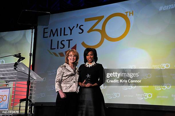 Gabrielle Giffords and Ayanna Pressley appear onstage at EMILY's List 30th Anniversary Gala at Washington Hilton on March 3, 2015 in Washington, DC.
